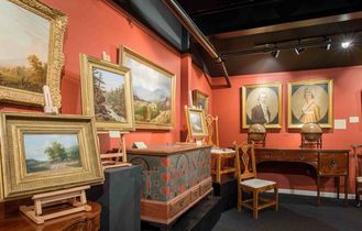 Fine art gallery at New Hampshire Antique Co-op with paintings and furniture